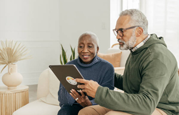 two people reading a tablet