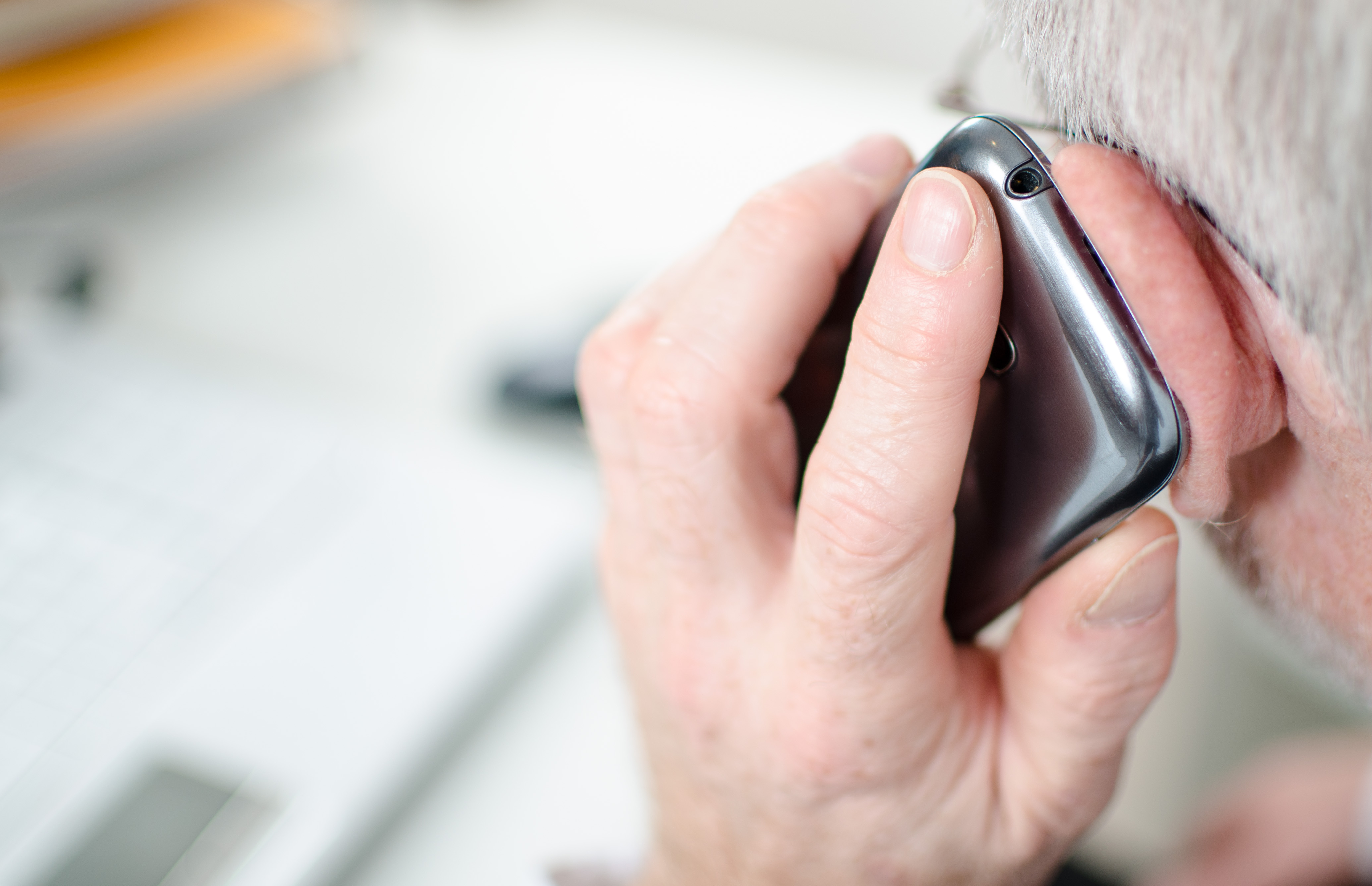 Elderly man listening to phone.